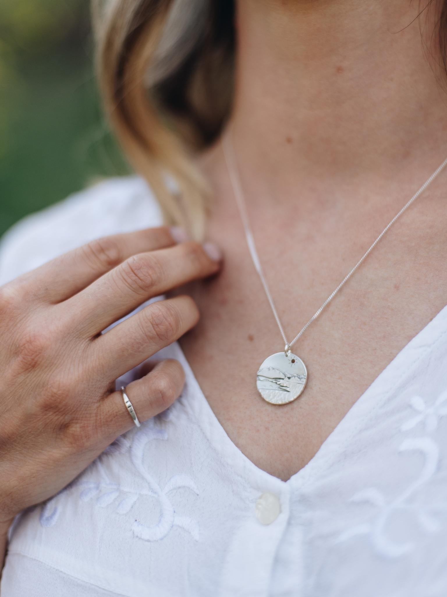 Sterling silver Kelowna BC pendant with mountains, okanagan lake and the iconic bridge.