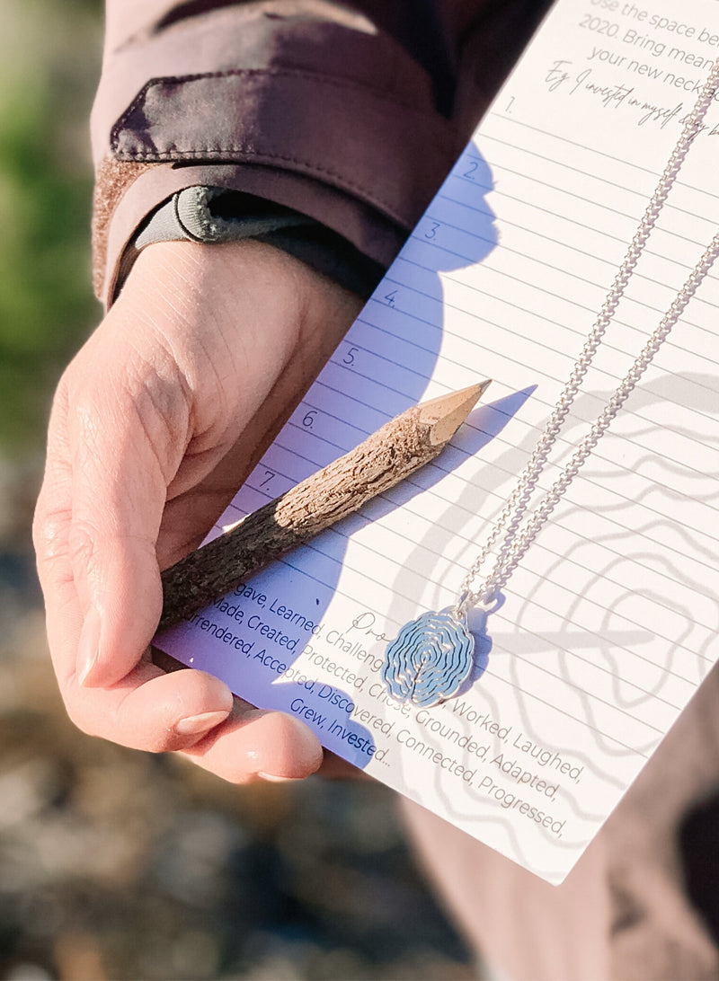 Self reflection and personal growth necklace in silver with journal prompts and tiny wood pencil.