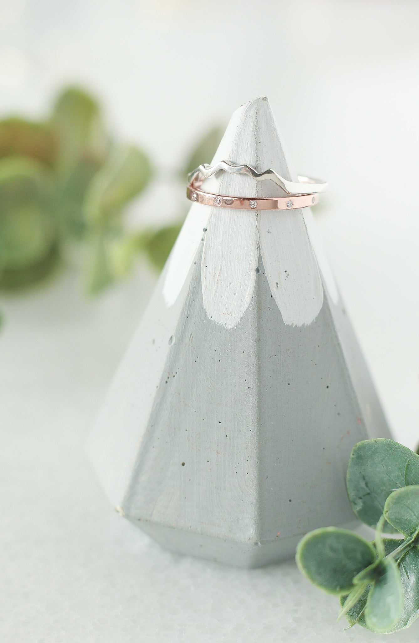 Rose gold diamond eternity ring paired with a white gold mountain ring.