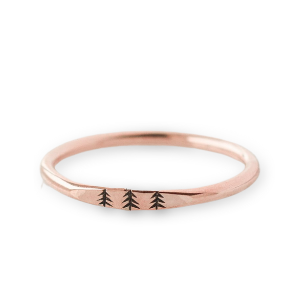 Rose gold dainty signet style ring with three trees engraved on the band.