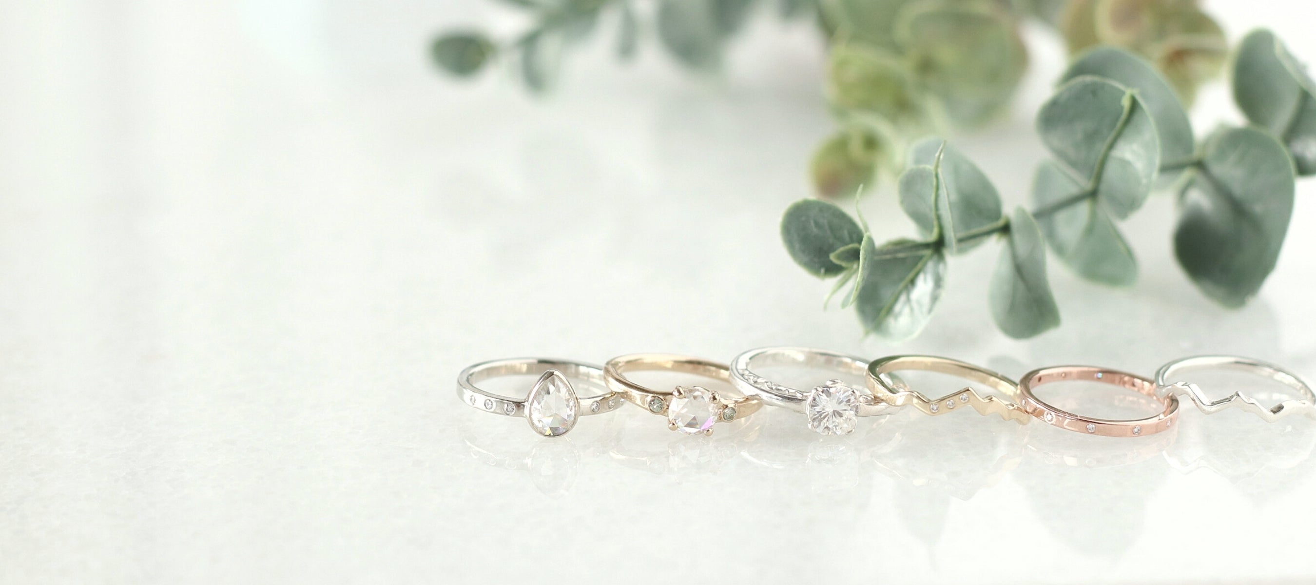 Group photo of Scenic Route Jewellery's personalized engagement and wedding rings in certified recycled gold.