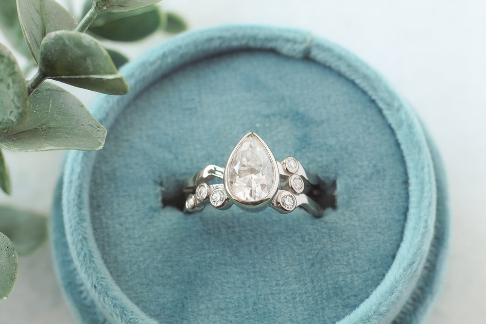 9x6 pear moissanite engagment ring set in 18k white palladium gold featuring Jasper, BC mountains and landscape..