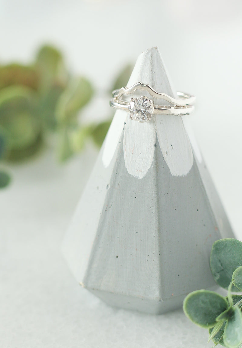White gold mountain ring with Mount Baker with a cushion cut moissanite engagement ring.