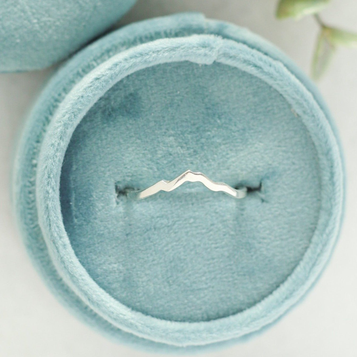 White gold mountain ring with Mount Baker in a velvet ring box.