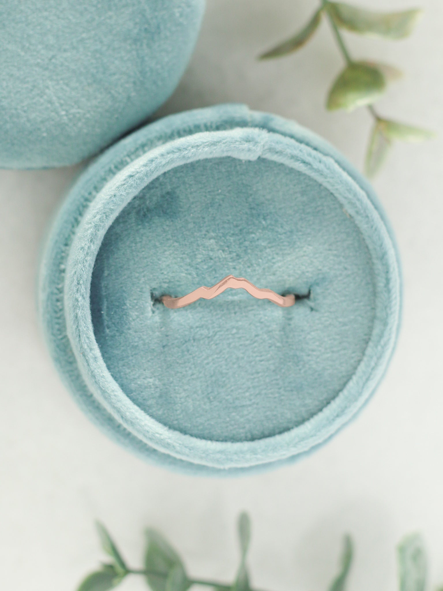 Rose gold mountain ring with Mount Baker in a velvet ring box.