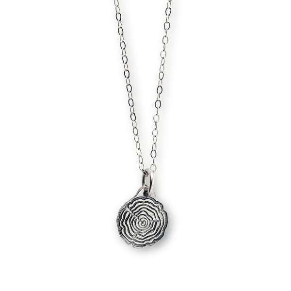 Silver tree slice necklace on a chain