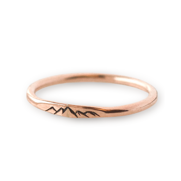 Rose gold stacking ring with engraved mountain details.