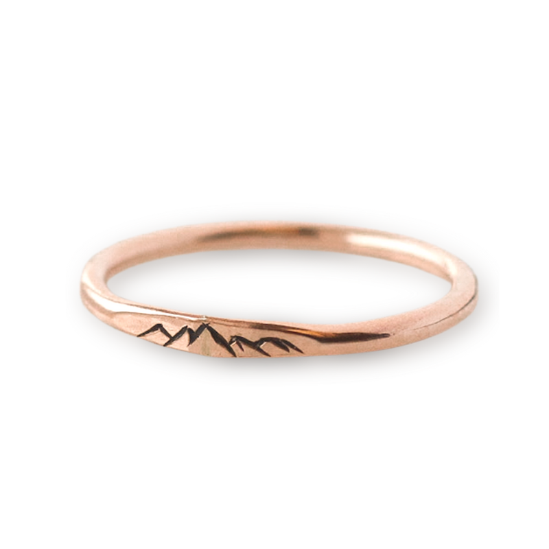 Rose gold stacking ring with engraved mountain details.